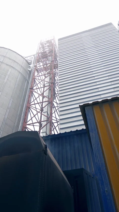 Storage granary technology tank. Big factory elevator construction. Vertical Stock Footage 317938881