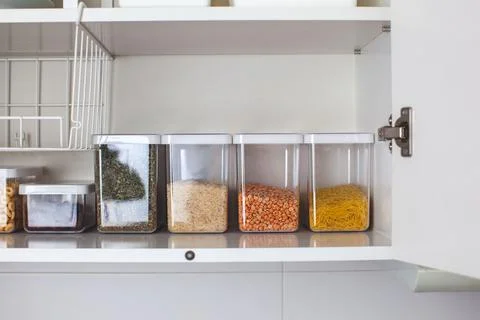Storage ideas in the kitchen. White box and basket. Shelf order system. Stock Photos