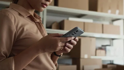 Storage Office Manager Using Smartphone when Working with Parcels Stock Footage 281716290