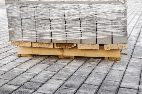 Storage of paving slabs on pallets at the construction site. Photos