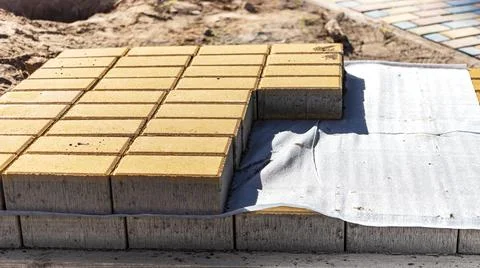 Storage of paving slabs on pallets at the construction site. Photos