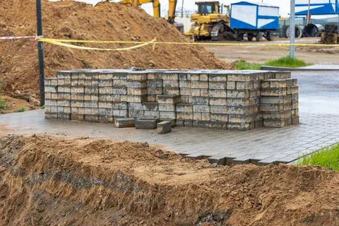 Storage of paving slabs on pallets at the construction site. Stock Photos
