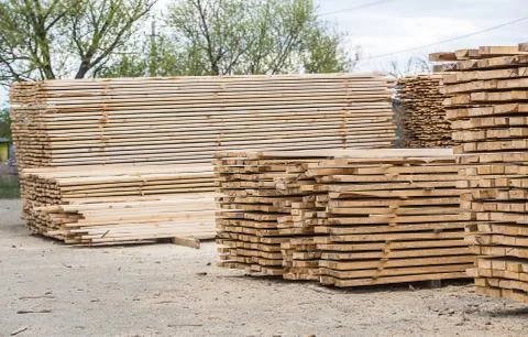 Storage of processed wood in stacks. Stock Photos