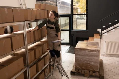 Storage room employee checking cardboard boxes barcode Stock-Fotos