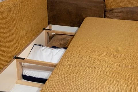 Storage space inside the sofa where the pillows are at home in the apartment, Stock Photos