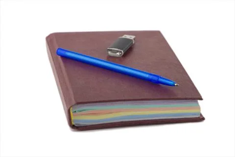 Storage systems: new red notebook, pen and flash drive on it, isolated on whi Stock Photos