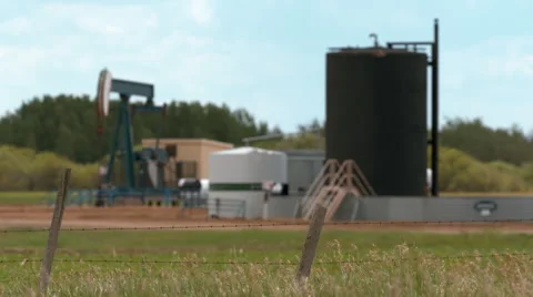 Storage tank and pump jack in the country side. Stock Footage 67613902