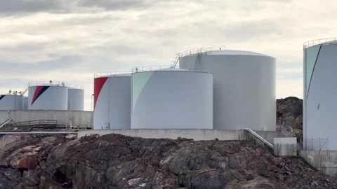 Storage tanks on a coastal area in a cloudy sky at a fuel facility Video stock 344801496