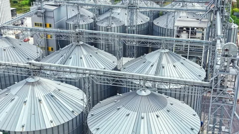 Storage tanks at a grain facility located in a rural area during the day with Stock Footage 341385006
