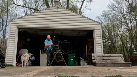 Storage unit cleanout. Man removing items from cluttered Garage Storage Stock Footage 201105168