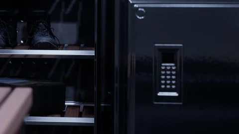 Storage unit with a lock and shelves showing black boots and boxes Stock Footage 345003176