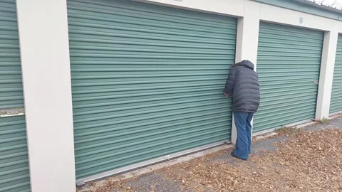 Storage unit, opening overhead door, mattress falling Stockbeeldmateriaal 256052480