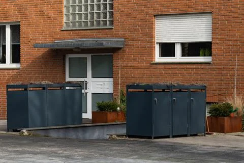 Storage unit for recycling bin in front of a brick building Stock Photos