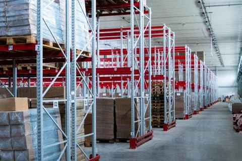 Storage warehouse and racks on which there are cardboard boxes with finished Stock Photos