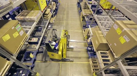 Storage worker on autoloader taking box from shelf and transporting. From above Stock Footage 61136129