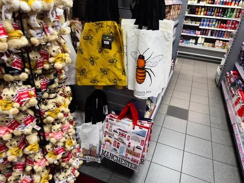 Store display with bee pattern tote bags and Manchester souvenir bags in a .. Stock Photos