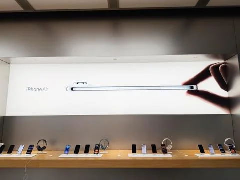 Store display featuring iPhone Air banner and a side view of a slim smartphon Stock Photos