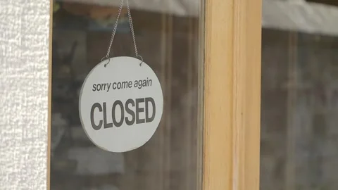 Store displays closed sign on its door Stock Footage 344890902