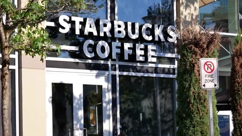 Store front of Starbucks coffee shop on sunny day in Coquitlam Canada Stock Footage 79840780