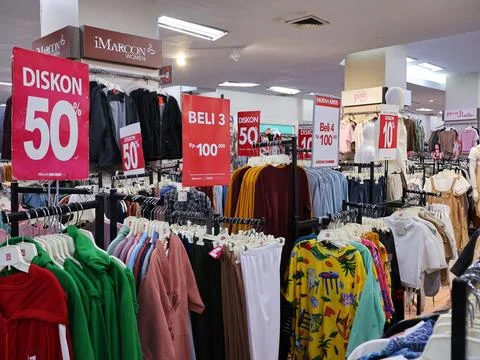 A store with a lot of various clothes model on display Stock Photos