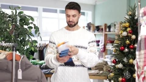 In store, man customer choose socks, X mas shopping Stock Footage 346125421