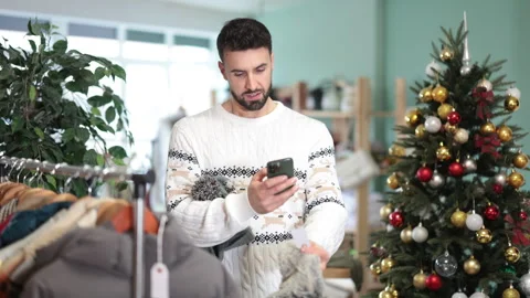 In store, man customer scan QR code on winter hat, X mas shopping. Stock Footage 329397155