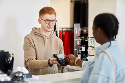 Store manager processing credit card payment 스톡 사진