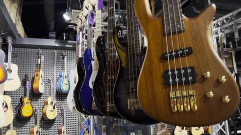 A store with musical instruments, classical and electric guitars Stock Photos