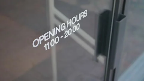 Store opening hours displayed on the door Stock Footage 344890723