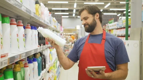Store supervisor with tablet pc in hand checking the quality of the product in Stock Footage 92209117