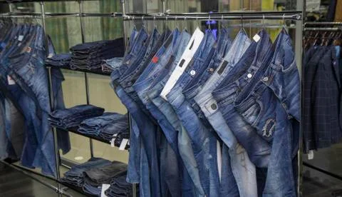Store warehouse, men and women , unisex jeans denim pants , a lot of jeans pa Stock Photos