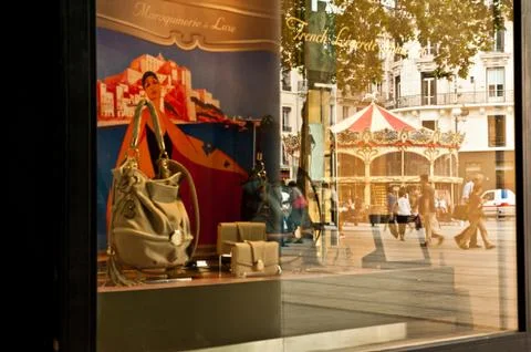 Store window and reflection of a carousel in Lyon, France. Stock Photos