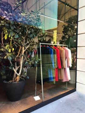 Store window display with clothes close-up. Coats on hangers. Fashion. retail.  Stock Photos