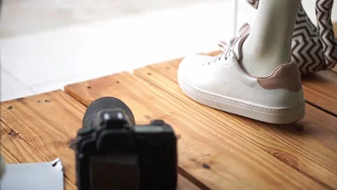 Store window made of pallet showing womens shoes and a black dslr camera. Stock Footage 153444842