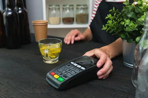 Store worker requesting for payment over nfc technology. Store worker holding Stock Photos