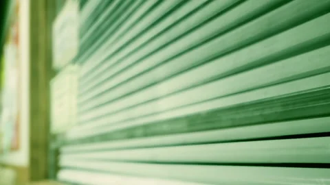 Storefront with closed metal shutter during the day Stock Footage 342810203