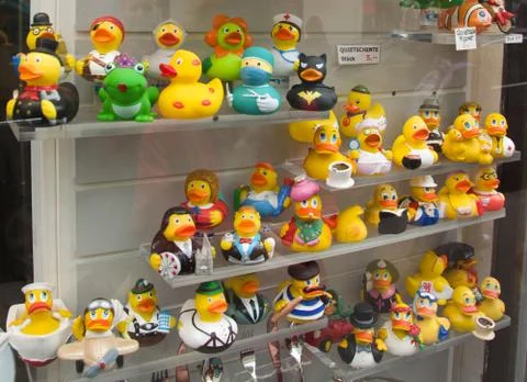 Storefront with rows of rubber ducks style of different characters Stock Photos