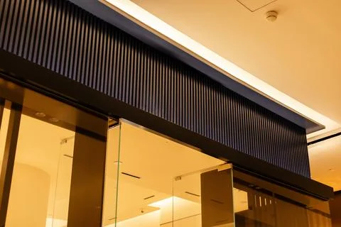 Storefront shows a blank facade with clear glass doors. There is space for .. Stock Photos