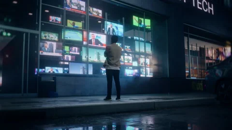Storefront Television Display with a Man Watching Broadcast Channel Stock Footage 295353545