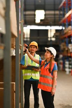 Storehouse employees using barcode scanner to scanning box and checking Stock Photos
