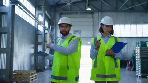 Storehouse specialists discussing tablet data inspecting shipping complex Stock Footage 169889976