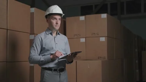 Storekeeper in the warehouse make an inventory. Stock Footage 140560020