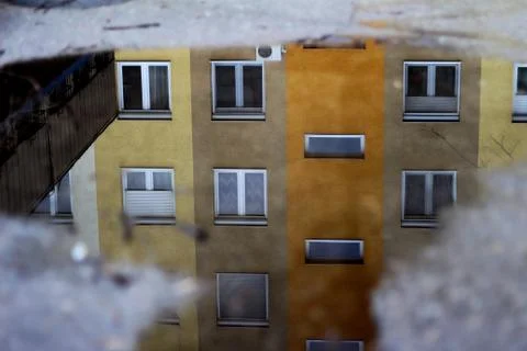 Storey Building Reflection in the Puddle 01 Stock Photos