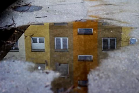 Storey Building Reflection in the Puddle 02 Stock Photos