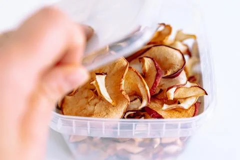 Storing apple chips in an eco-plastic box Stock Photos