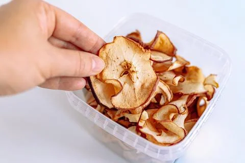Storing apple chips in an eco-plastic box Stock Photos