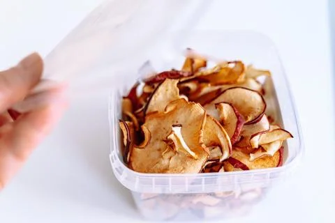 Storing apple chips in an eco-plastic box Stock Photos
