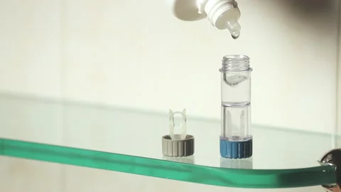 Storing contact lenses in the container, Replacing contact lens fluid Video stock 220725309
