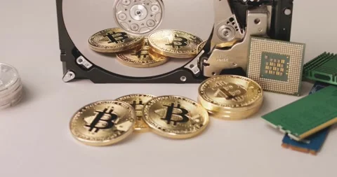 Storing Crypto data on Hard drive concept. Bitcoin coins next to HDD and CPU Stock Footage 172129257