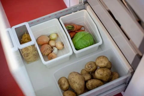 Storing vegetables in the kitchen. Stock Photos
